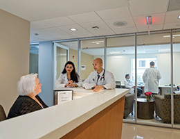 Doctors talking to a receptionist. Links to Beneficiary Designations Doctors talking to a receptionist. Links to Beneficiary Designations
